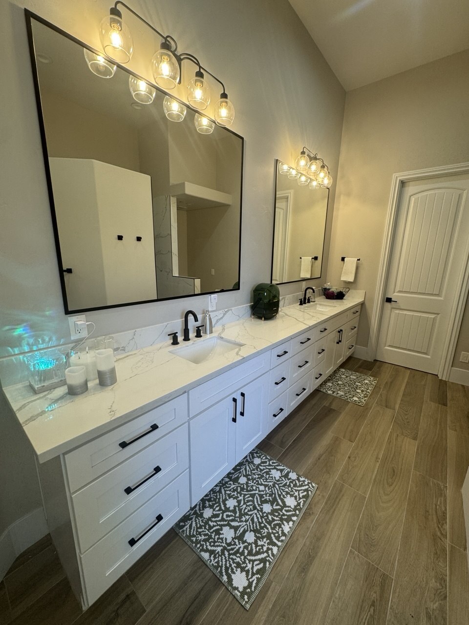 The same Las Vegas bathroom vanity after packing — counter cleared to bare quartz with only a tray, candles and a vase left out