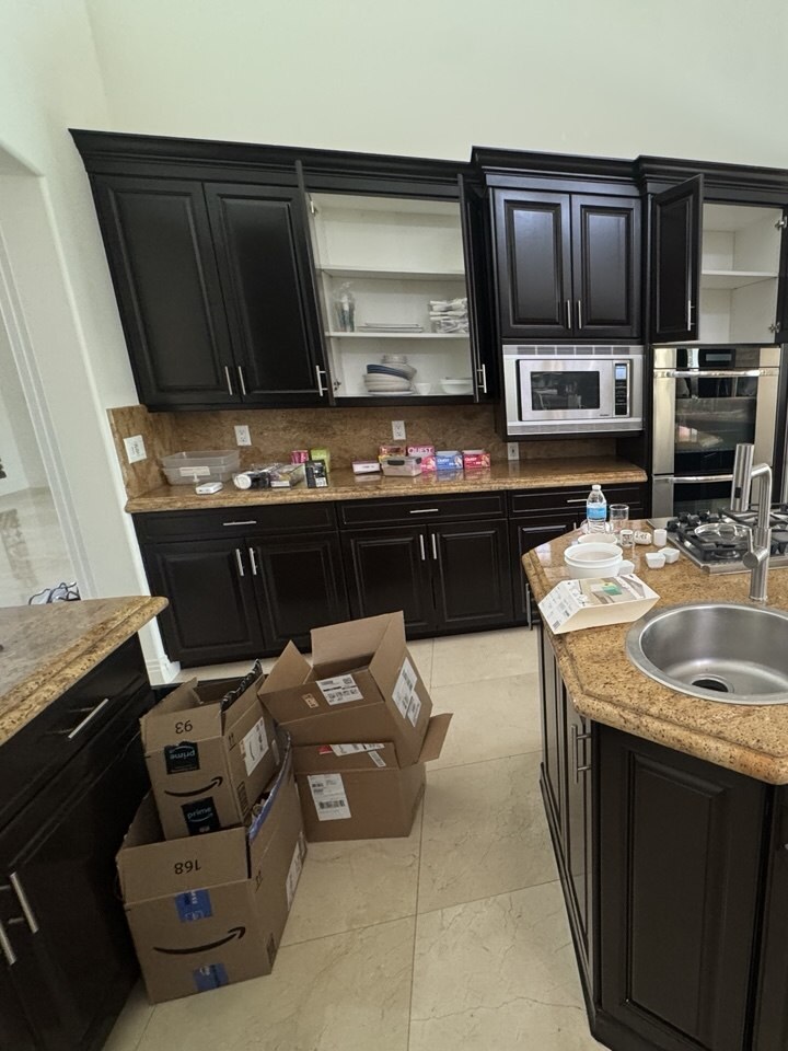 Kitchen cabinets emptied shelf by shelf into numbered moving boxes during a packing service in Las Vegas