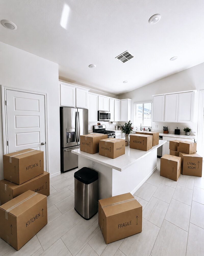 Labeled moving boxes filling a bright white Las Vegas kitchen on move-in day — Lifelystyle move-in concierge unpacks, organizes, and makes your home fully livable by evening of Day One